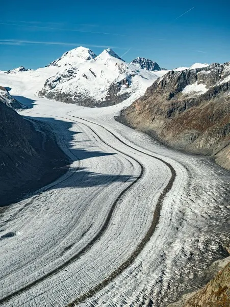 A sweeping view of the majestic Aletsch Glacier winding through the Swiss Alps.